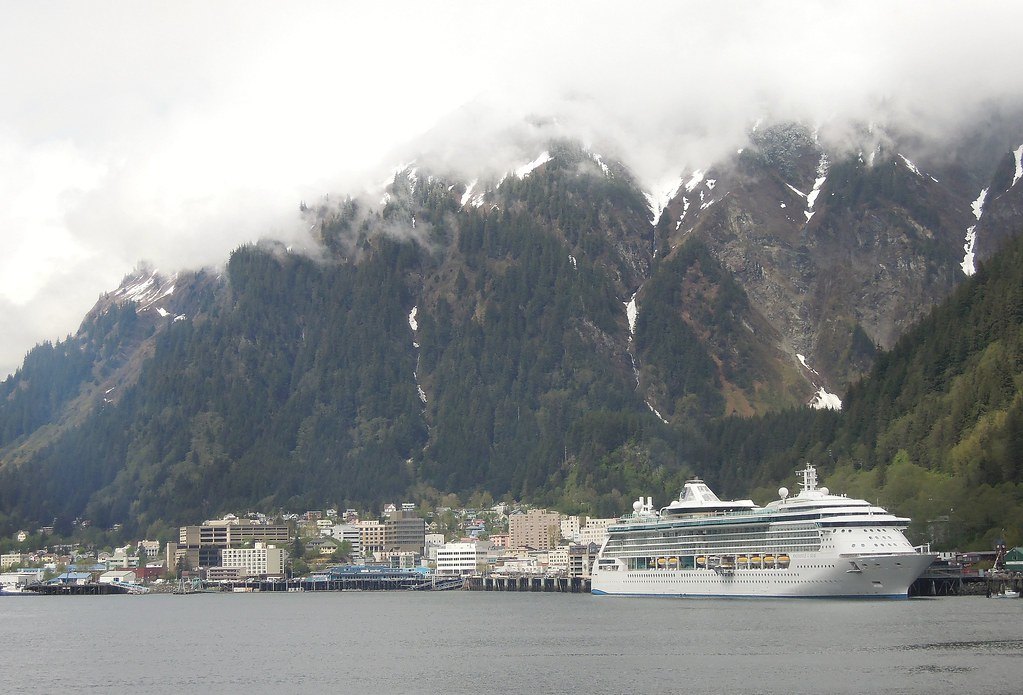 Juneau, Alaska, with a cruise ship at the dock and snowy mountains behind the town