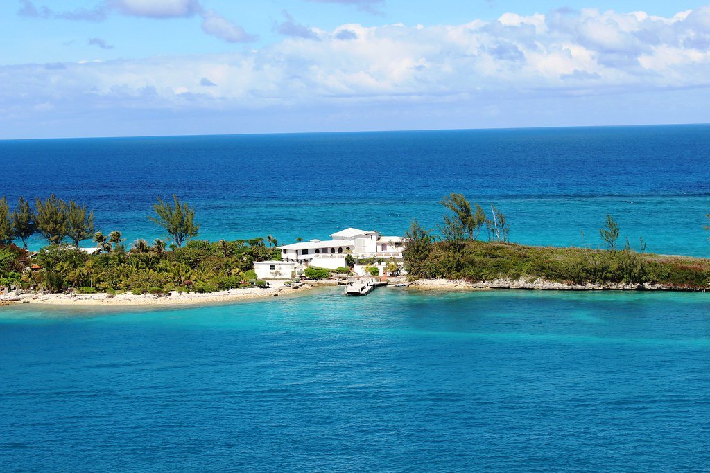 Turquoise water off Nassau in the Bahamas, with a small island and white houses